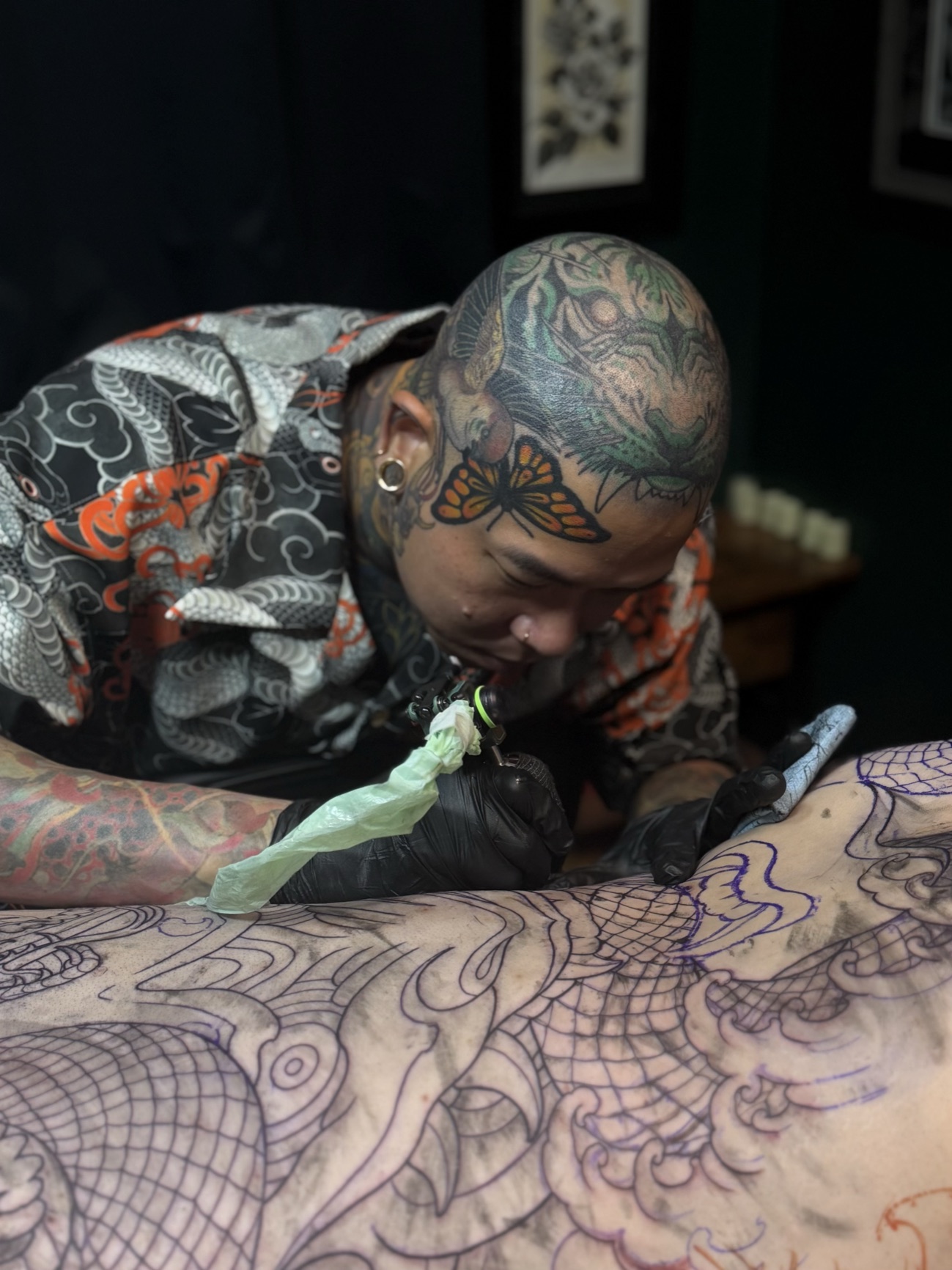 Brian Divine tattooing a large Japanese-style back piece