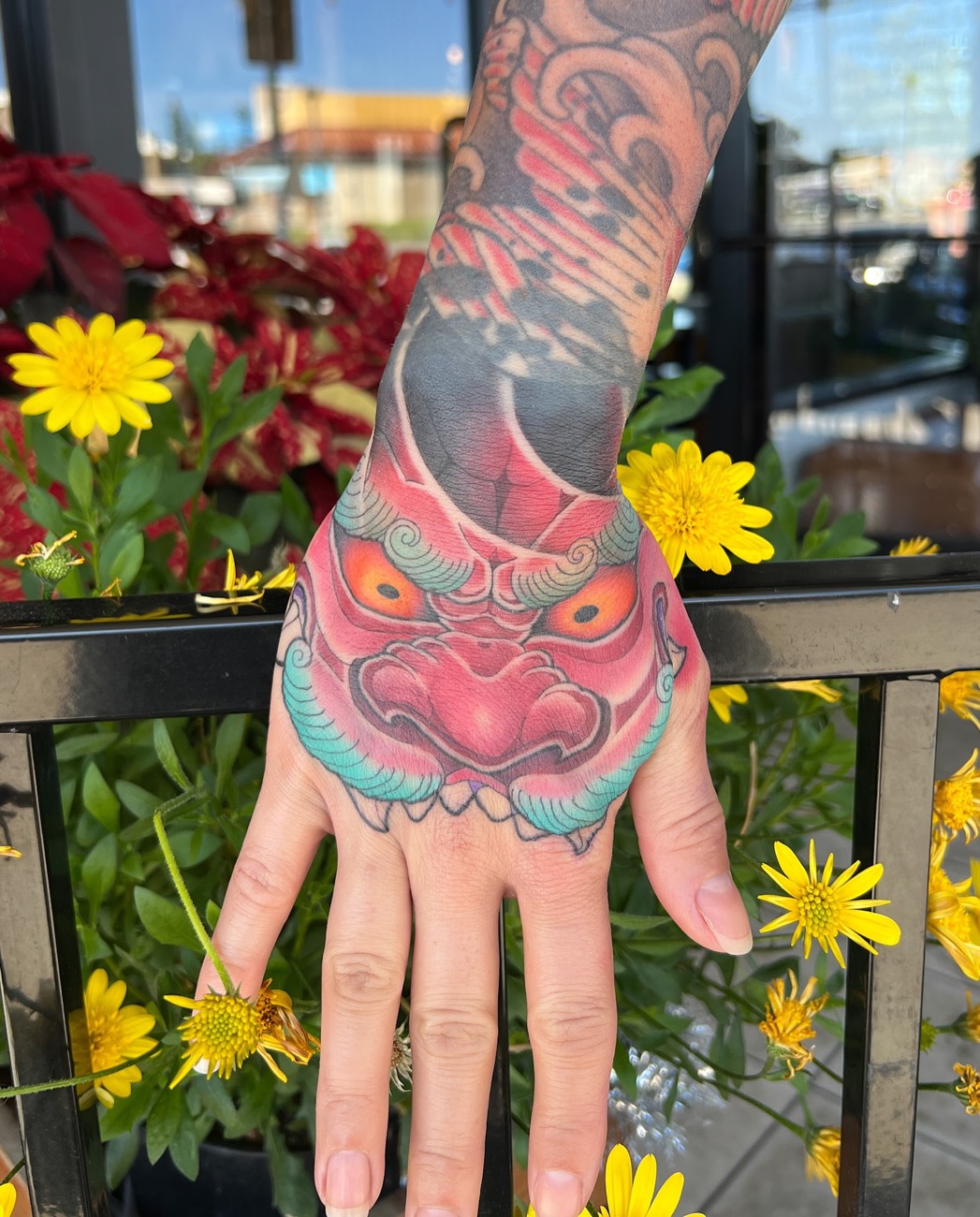 Red foo-dog hand tattoo